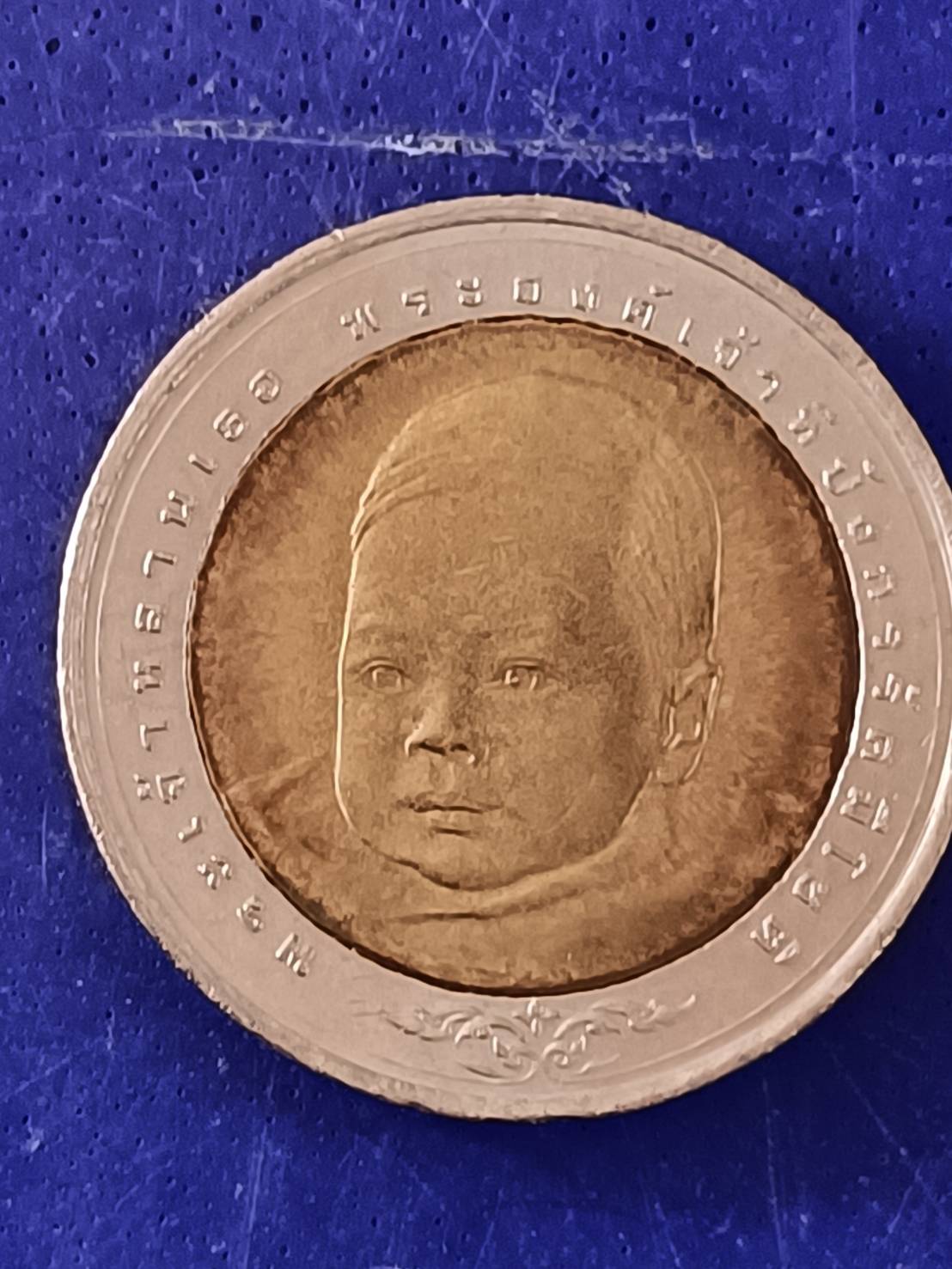 เหรียญ 10 บาท สองสี ที่ระลึกพระราชพิธีสมโภชเดือนและขึ้นพระอู่พระเจ้าหลานเธอ พระองค์เจ้าทีปังกรรัศมีโชติ 17 มิถุนายน 2548